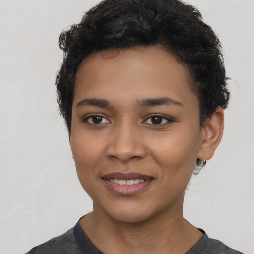 Joyful latino young-adult female with short  black hair and brown eyes
