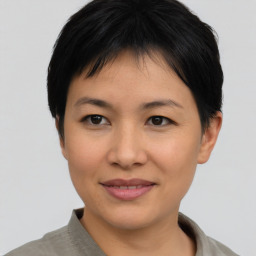 Joyful asian young-adult female with short  black hair and brown eyes