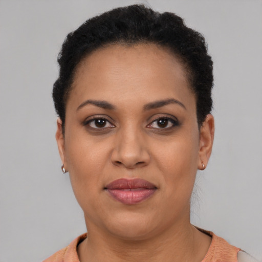 Joyful black young-adult female with short  brown hair and brown eyes