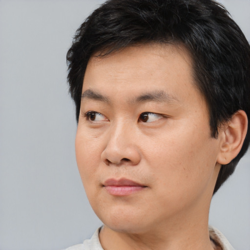 Neutral asian young-adult male with short  black hair and brown eyes