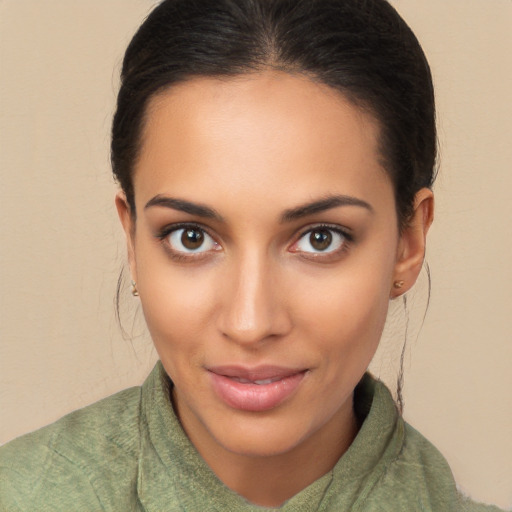 Joyful latino young-adult female with medium  brown hair and brown eyes