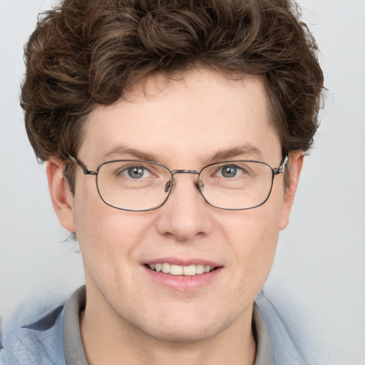 Joyful white adult male with short  brown hair and blue eyes