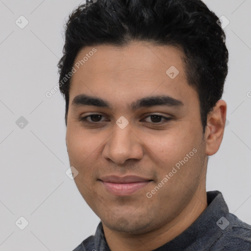 Joyful latino young-adult male with short  black hair and brown eyes