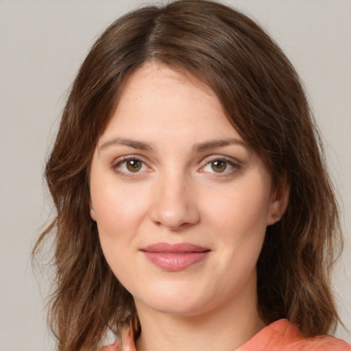 Joyful white young-adult female with medium  brown hair and green eyes