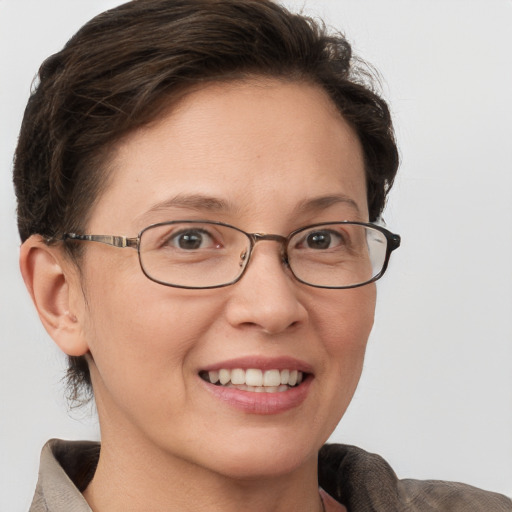 Joyful white adult female with short  brown hair and grey eyes