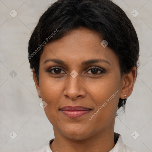 Joyful black young-adult female with short  brown hair and brown eyes