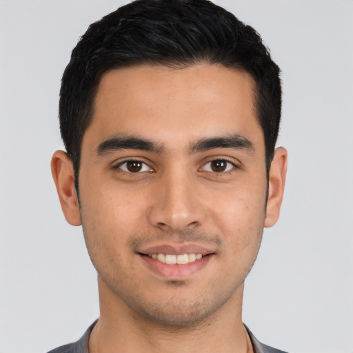 Joyful latino young-adult male with short  black hair and brown eyes