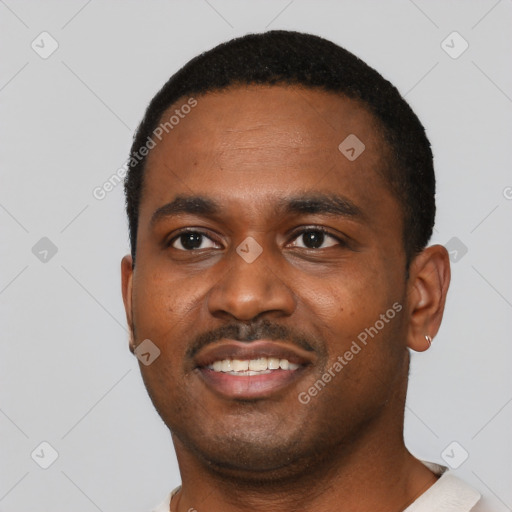 Joyful black young-adult male with short  black hair and brown eyes