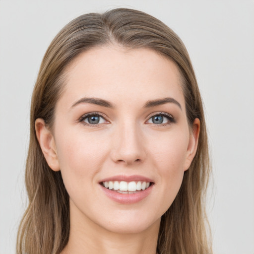 Joyful white young-adult female with long  brown hair and grey eyes