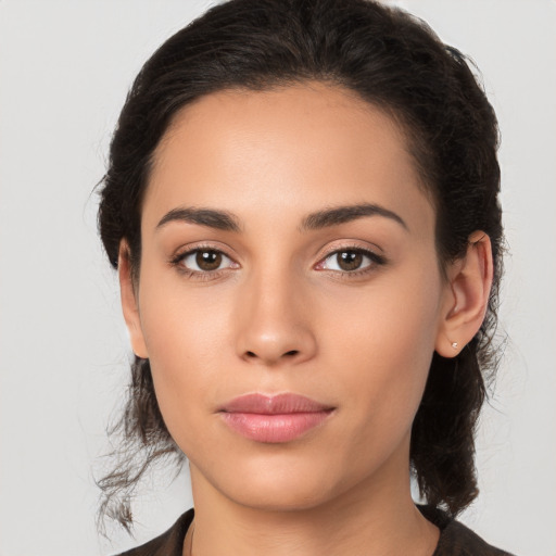 Joyful latino young-adult female with medium  brown hair and brown eyes