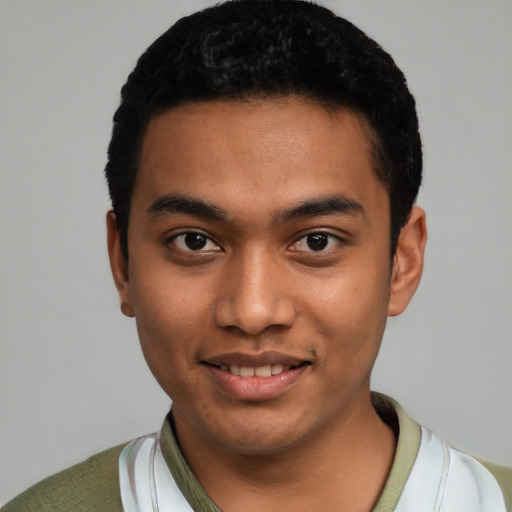 Joyful latino young-adult male with short  black hair and brown eyes