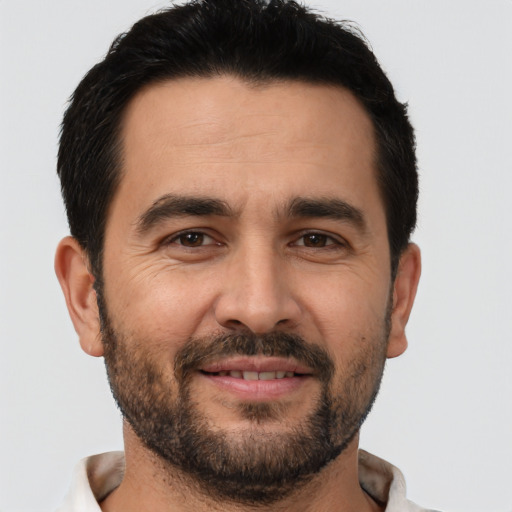 Joyful white adult male with short  brown hair and brown eyes
