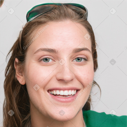 Joyful white young-adult female with long  brown hair and green eyes