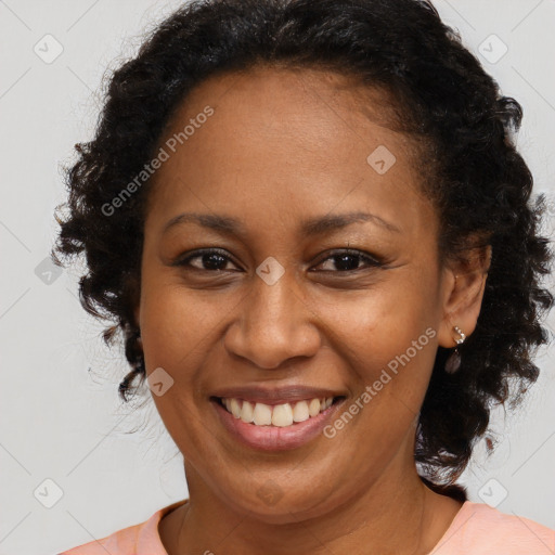 Joyful black adult female with medium  brown hair and brown eyes