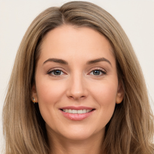 Joyful white young-adult female with long  brown hair and brown eyes