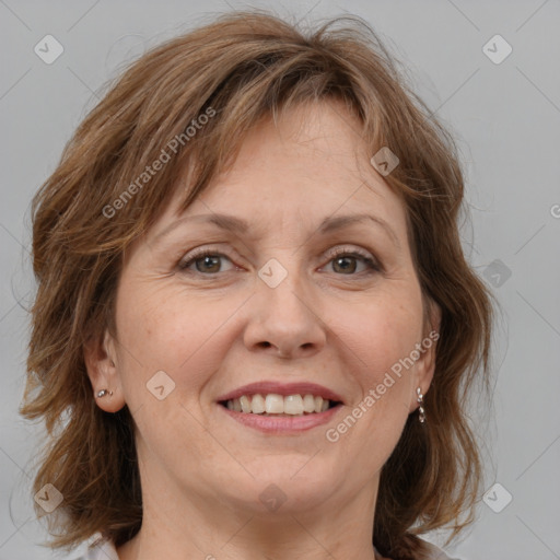 Joyful white adult female with medium  brown hair and grey eyes