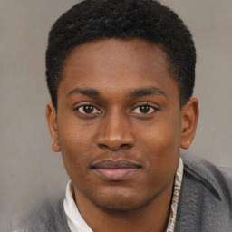 Joyful black young-adult male with short  brown hair and brown eyes