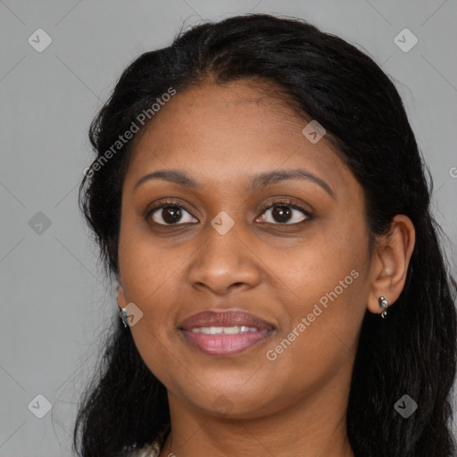 Joyful black adult female with long  brown hair and brown eyes