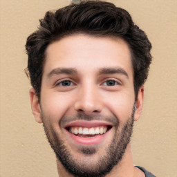 Joyful white young-adult male with short  black hair and brown eyes