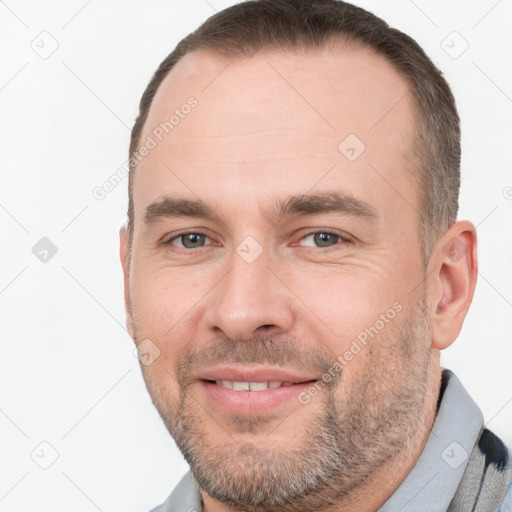 Joyful white adult male with short  brown hair and brown eyes