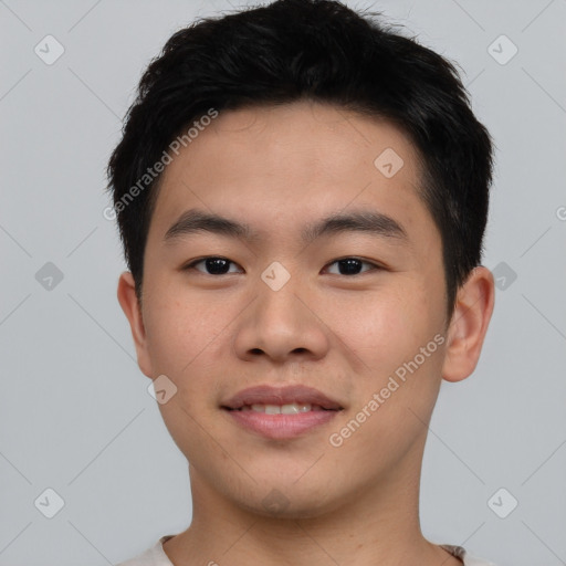 Joyful asian young-adult male with short  black hair and brown eyes