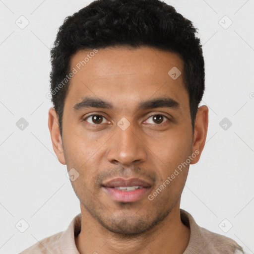 Joyful latino young-adult male with short  black hair and brown eyes