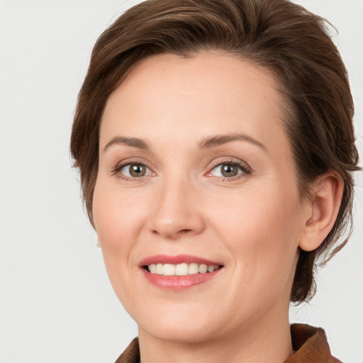 Joyful white young-adult female with medium  brown hair and green eyes