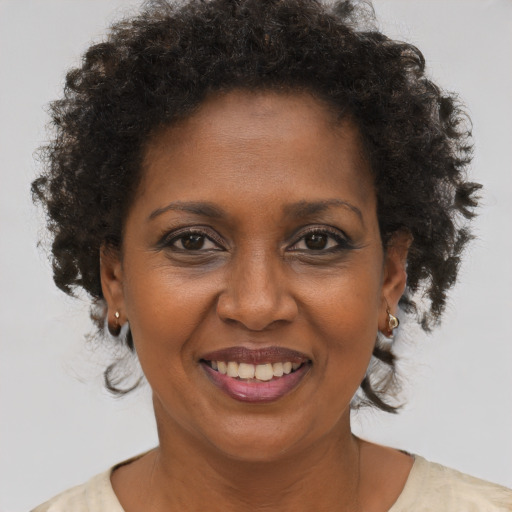 Joyful black adult female with short  brown hair and brown eyes