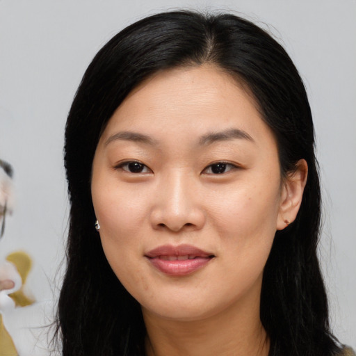 Joyful asian young-adult female with long  black hair and brown eyes