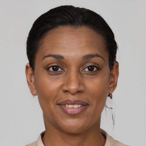 Joyful latino adult female with short  brown hair and brown eyes
