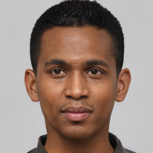 Joyful black young-adult male with short  black hair and brown eyes