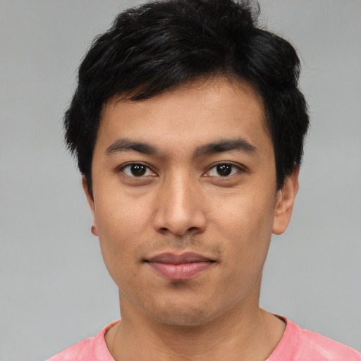 Joyful asian young-adult male with short  black hair and brown eyes