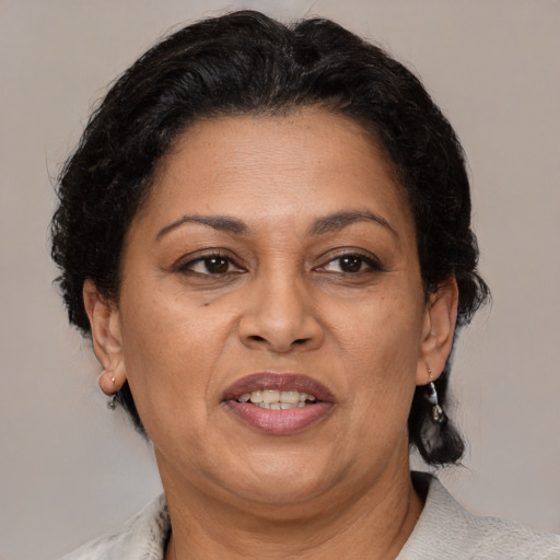 Joyful black adult female with medium  brown hair and brown eyes