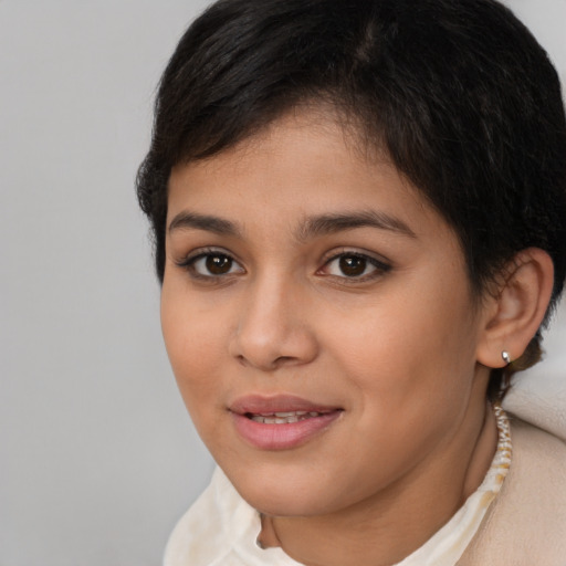 Joyful latino young-adult female with short  brown hair and brown eyes