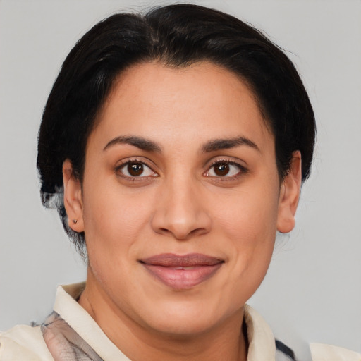 Joyful latino adult female with short  brown hair and brown eyes