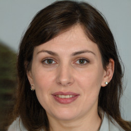 Joyful white adult female with medium  brown hair and brown eyes