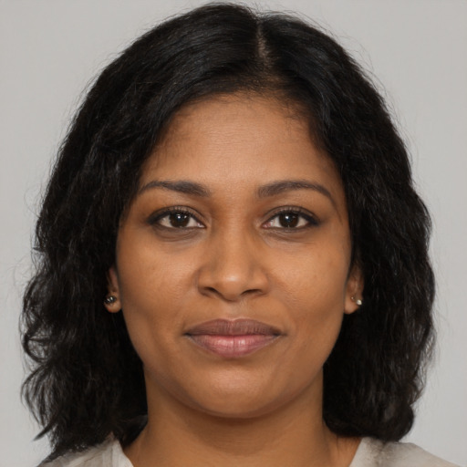 Joyful black young-adult female with medium  brown hair and brown eyes