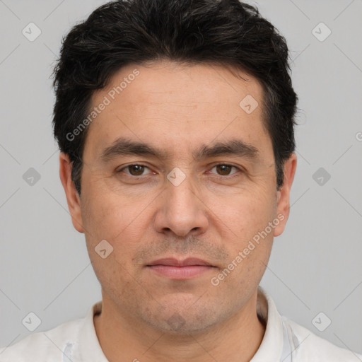 Joyful white adult male with short  black hair and brown eyes