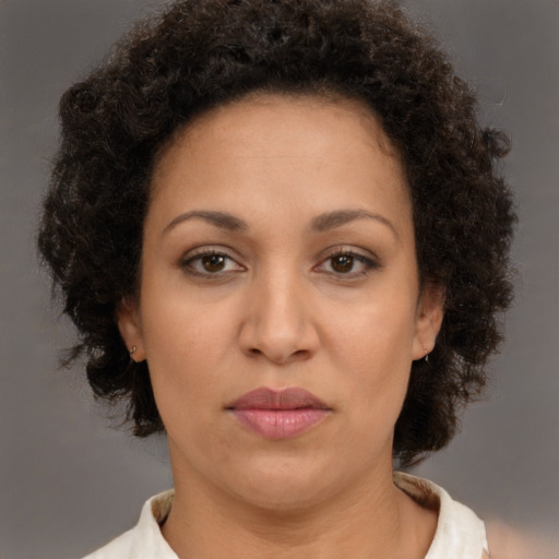 Neutral latino adult female with medium  brown hair and brown eyes