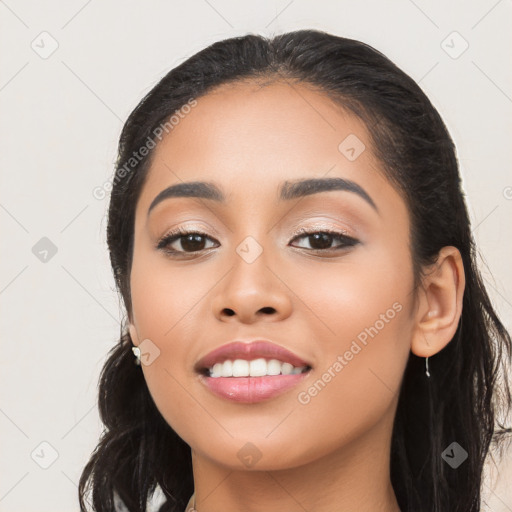 Joyful latino young-adult female with long  black hair and brown eyes