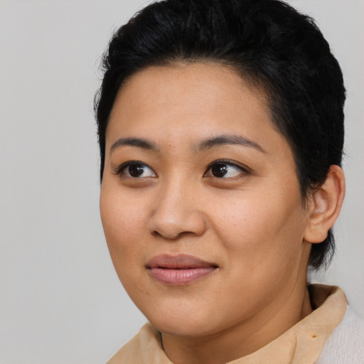 Joyful asian young-adult female with short  brown hair and brown eyes