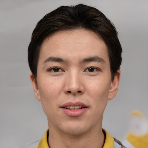 Joyful asian young-adult male with short  brown hair and brown eyes