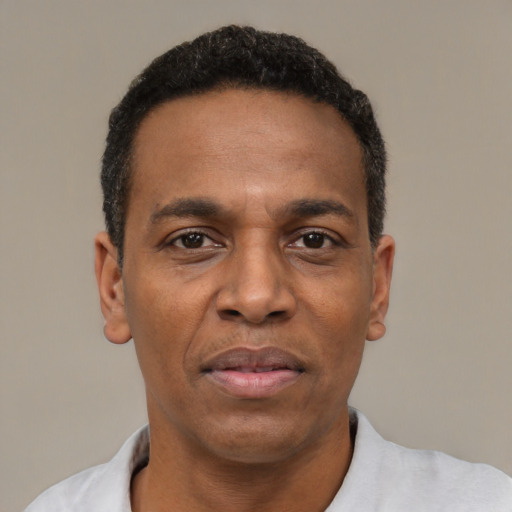 Neutral latino adult male with short  black hair and brown eyes