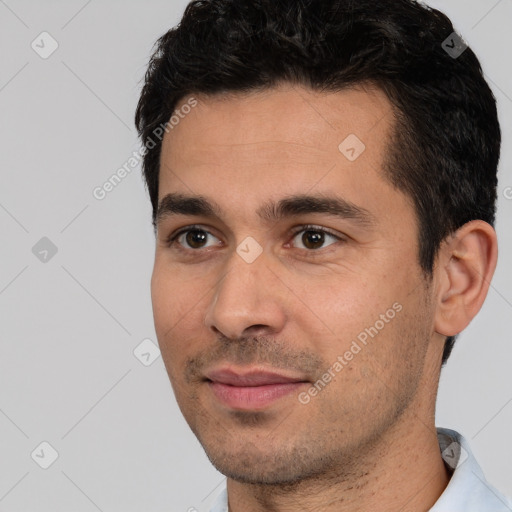 Joyful white young-adult male with short  black hair and brown eyes