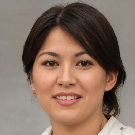 Joyful asian young-adult female with medium  brown hair and brown eyes