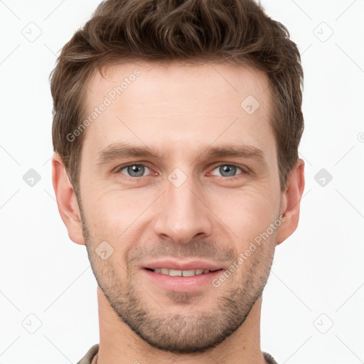 Joyful white young-adult male with short  brown hair and grey eyes