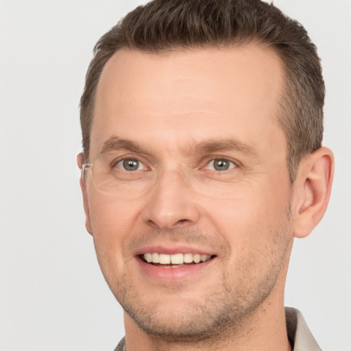 Joyful white adult male with short  brown hair and grey eyes