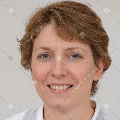 Joyful white adult female with medium  brown hair and blue eyes