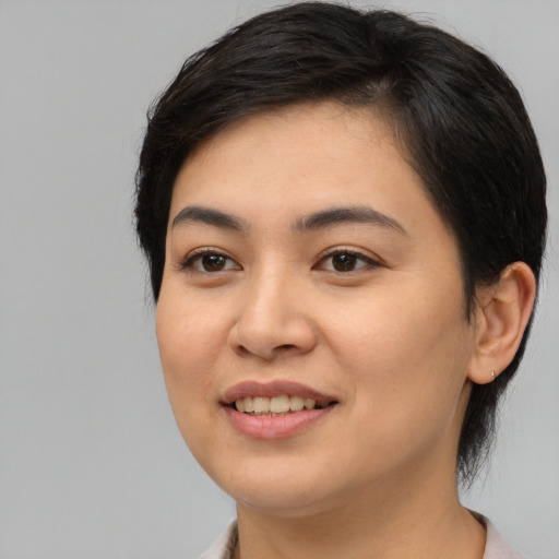 Joyful asian young-adult female with medium  brown hair and brown eyes