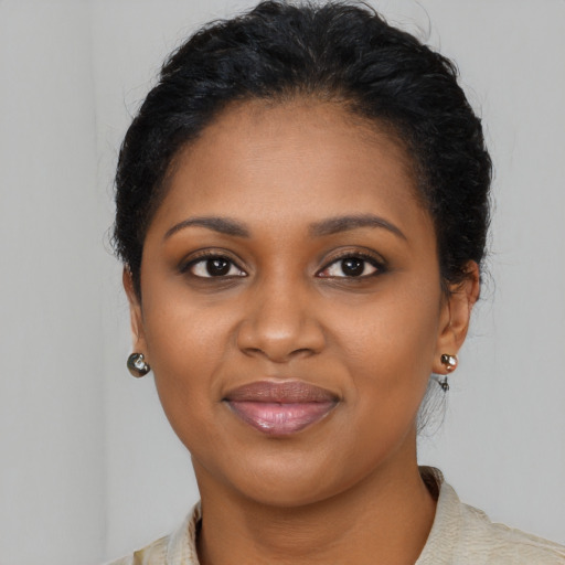 Joyful black young-adult female with medium  brown hair and brown eyes